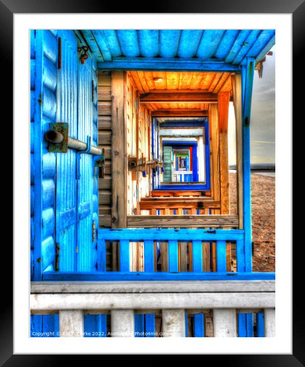 Looking through the beach huts Framed Mounted Print by Robin Clarke