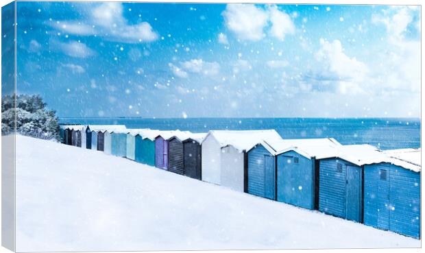 Beach huts in the snow at Frinton on Sea Canvas Print by Paula Tracy