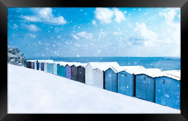 Beach huts in the snow at Frinton on Sea Framed Print by Paula Tracy