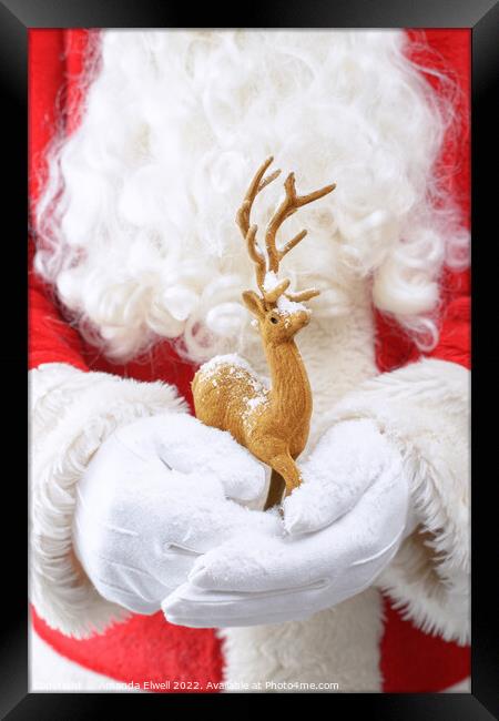 Santa Holding Reindeer Figure Framed Print by Amanda Elwell