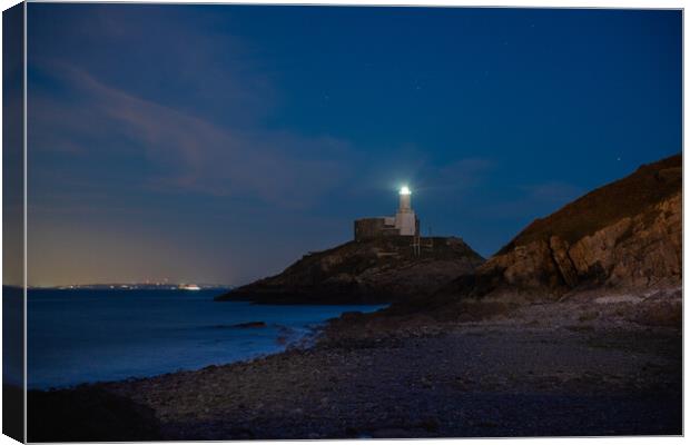 Mumbles lighthouse at night Canvas Print by Bryn Morgan