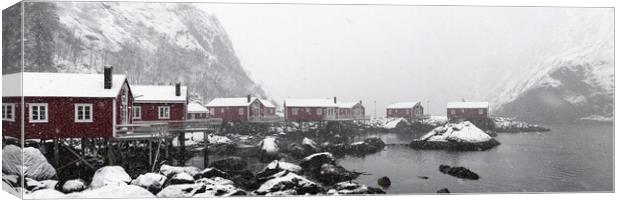 Nusfjord Red cabins huts covered in snow Lofoten Islands in the  Canvas Print by Sonny Ryse