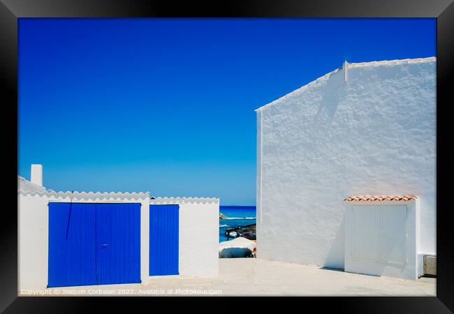 Fisherman's hut with white walls and colorful blue wooden doors  Framed Print by Joaquin Corbalan