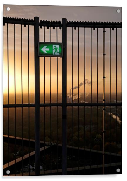 An emergency exit sign with an industrial site in the background Acrylic by Lensw0rld 