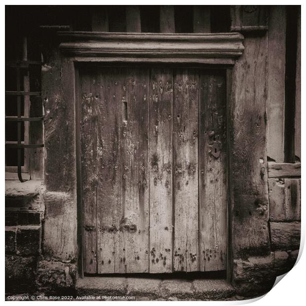 Ancient weathered wooden doorway Print by Chris Rose
