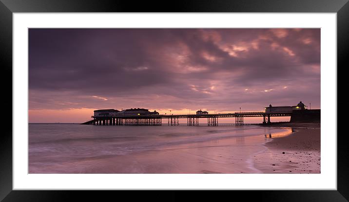 Cromer Pier - pink Framed Mounted Print by Simon Wrigglesworth