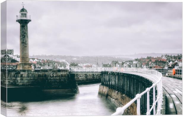 The Harbour Lighthouse & Curved Pier At Whitby On A Cold Winters Canvas Print by Peter Greenway
