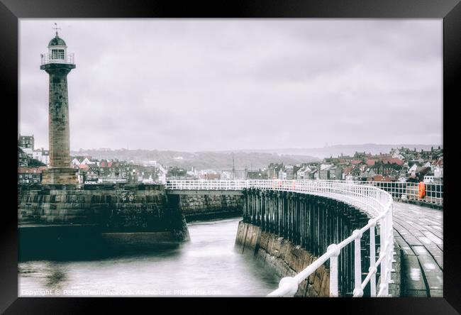 The Harbour Lighthouse & Curved Pier At Whitby On A Cold Winters Framed Print by Peter Greenway