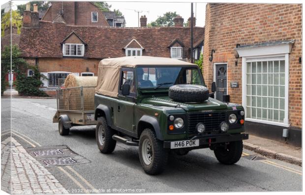 Landrover Defender pulling truck with a bale of hay, Canvas Print by Kevin Hellon