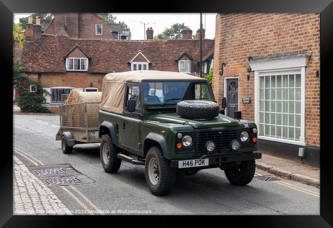 Landrover Defender pulling truck with a bale of hay, Framed Print by Kevin Hellon