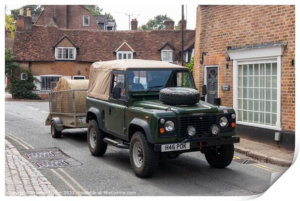 Landrover Defender pulling truck with a bale of hay, Print by Kevin Hellon