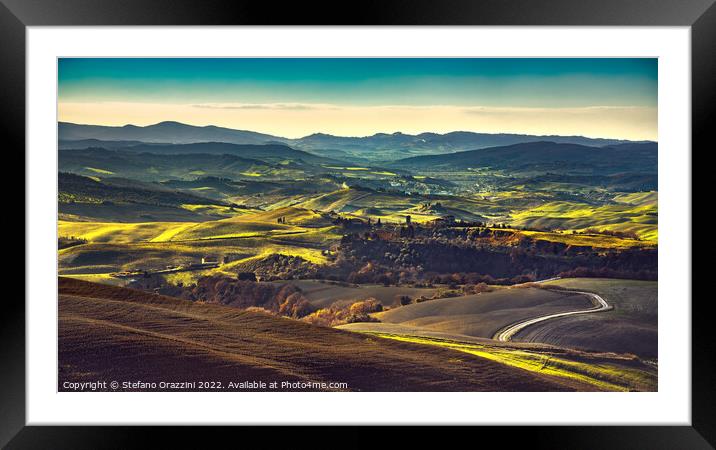Volterra winter panorama, rolling hills and green fields at sunset Framed Mounted Print by Stefano Orazzini