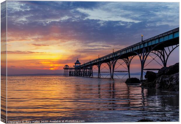 Pier at sunset with golden sunlight Canvas Print by Rory Hailes
