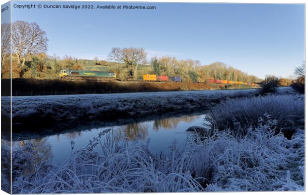 Freightliner passes the white frozen landscape of the river Avon near Freshford Canvas Print by Duncan Savidge