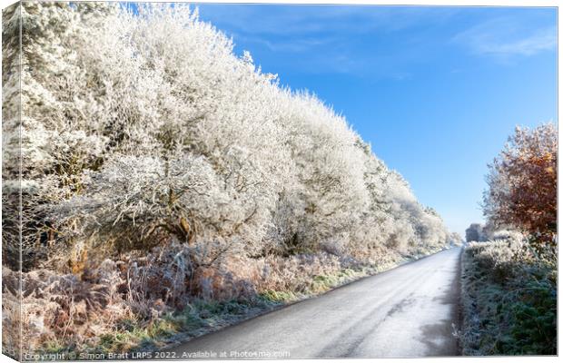 Amazing frozen trees on rural icy UK road Canvas Print by Simon Bratt LRPS