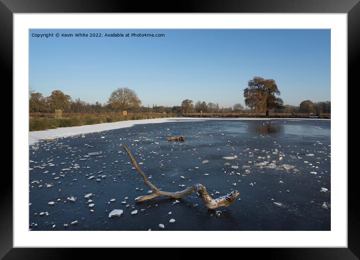 Frozen log on frozen pond Framed Mounted Print by Kevin White