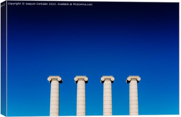 Four classical ionic columns, isolated on blue sky background Canvas Print by Joaquin Corbalan