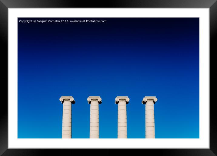 Four classical ionic columns, isolated on blue sky background Framed Mounted Print by Joaquin Corbalan