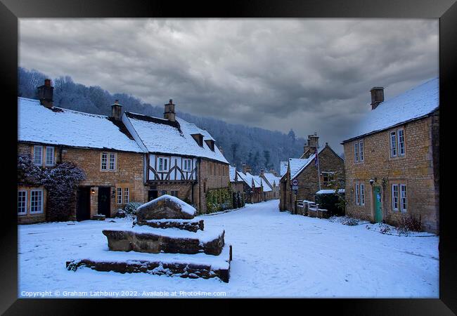 Castle Combe, Cotswolds, in the snow Framed Print by Graham Lathbury