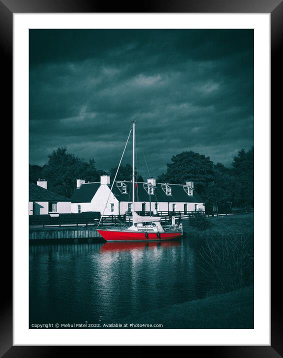 Red sailboat moored in water near traditional style homes Framed Mounted Print by Mehul Patel