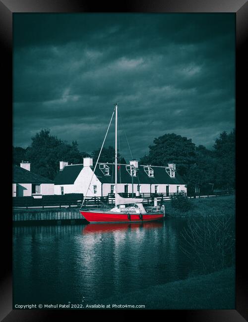Red sailboat moored in water near traditional style homes Framed Print by Mehul Patel