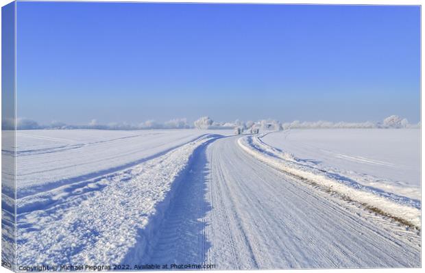 View of a snow-covered country road in winter with sunshine and blue sky Canvas Print by Michael Piepgras