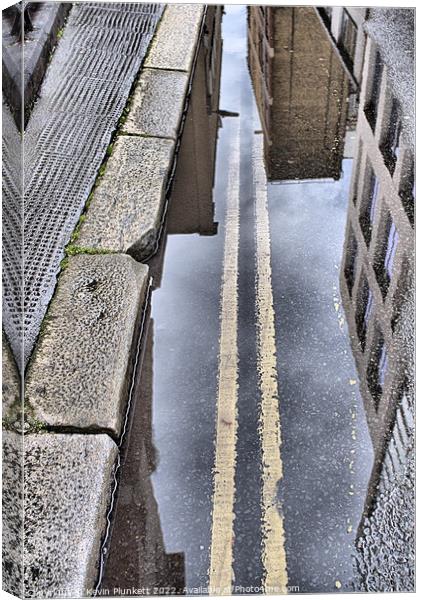Road Puddle Canvas Print by Kevin Plunkett