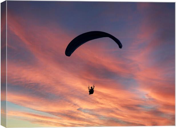 Paragliding the Sunset Canvas Print by Glen Allen