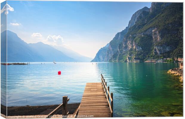 Wooden pier on the lake. Riva del Garda, Italy Canvas Print by Stefano Orazzini