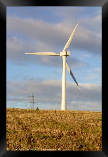 A modern zero emmissions wind turbine located on the road from N Framed Print by Michael Harper
