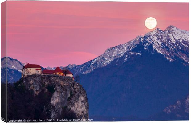 Full moon rising at sunset beside the castle at Lake Bled Canvas Print by Ian Middleton