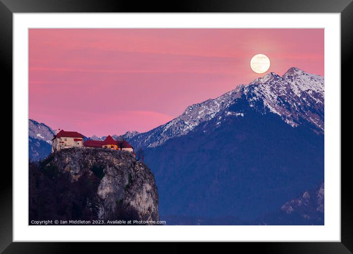 Full moon rising at sunset beside the castle at Lake Bled Framed Mounted Print by Ian Middleton
