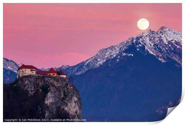 Full moon rising at sunset beside the castle at Lake Bled Print by Ian Middleton