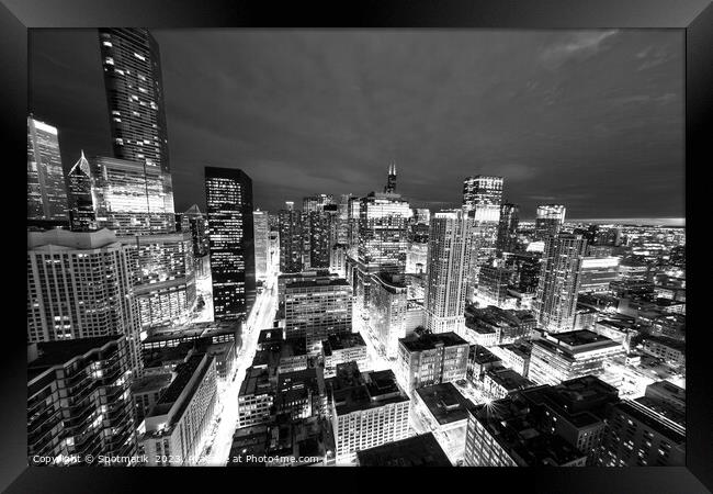 Aerial Chicago skyscrapers illuminated at night  Framed Print by Spotmatik 