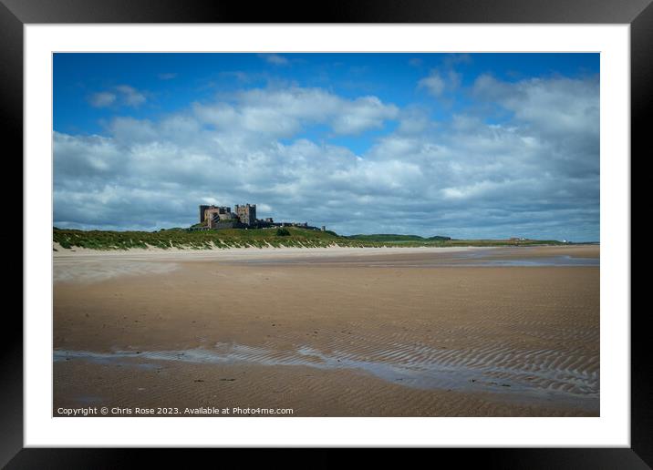 Bamburgh Castle on the horizon above Bamburgh beac Framed Mounted Print by Chris Rose