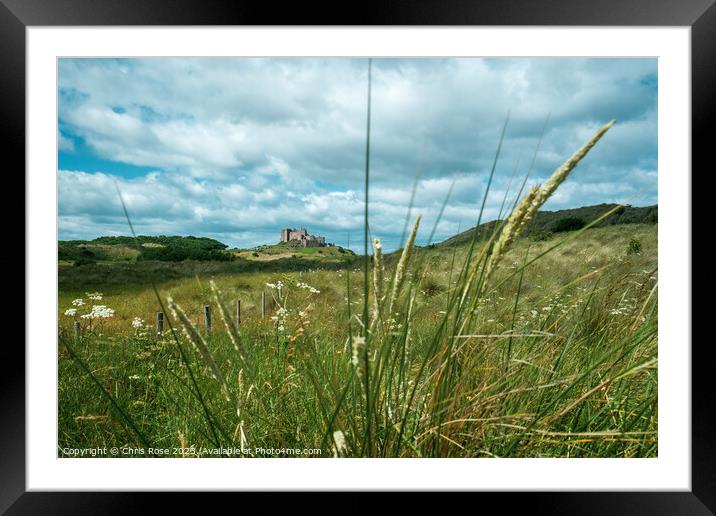 Bamburgh Castle glimpsed in the distance Framed Mounted Print by Chris Rose