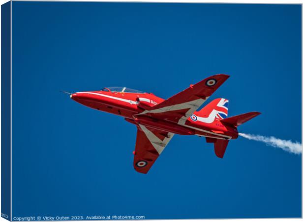 Red arrow flying through a blue sky Canvas Print by Vicky Outen