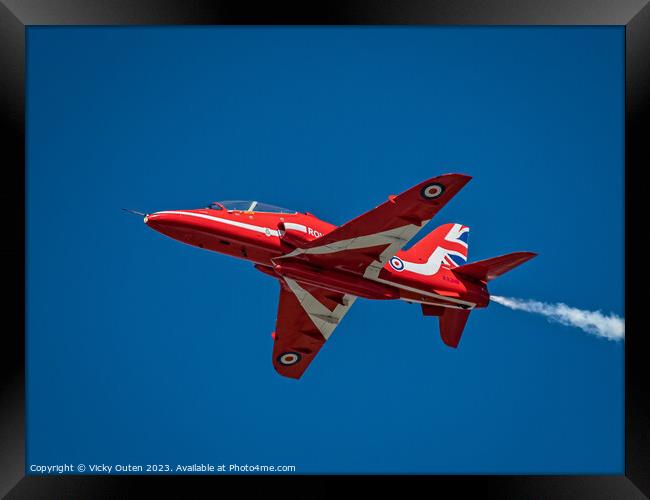 Red arrow flying through a blue sky Framed Print by Vicky Outen