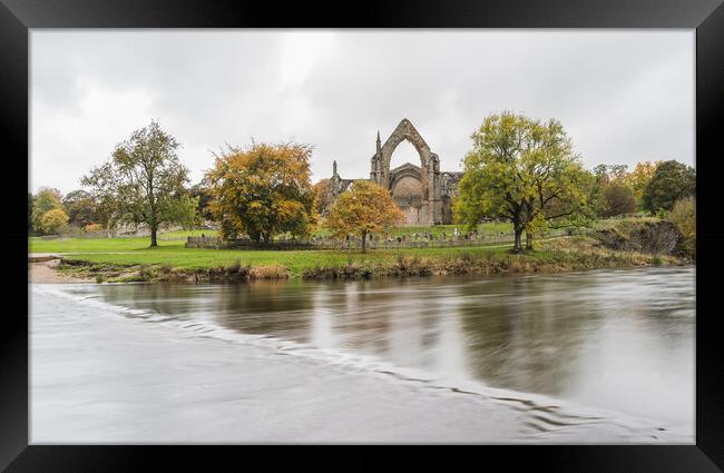 Bolton Abbey over submerged stepping stones Framed Print by Jason Wells