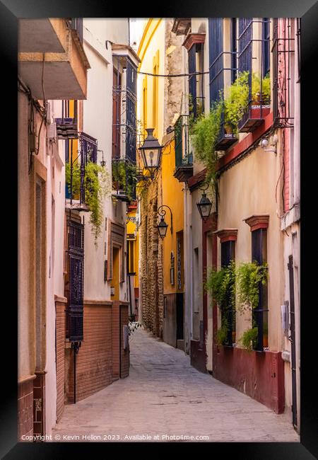 Narrow street in Seville, Spain Framed Print by Kevin Hellon