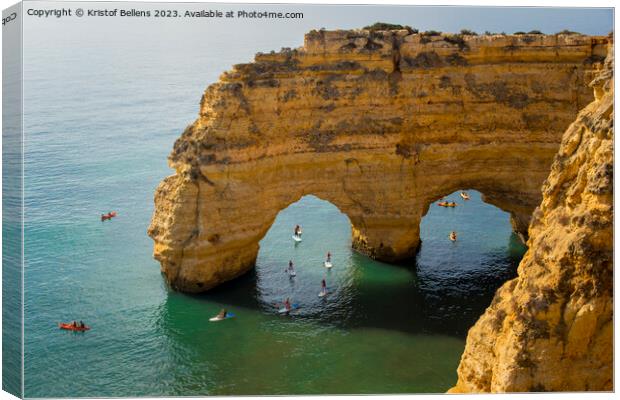 Kayaks and sup boards peddling under the Arco Natural on the Algarve coast in Portugal. Canvas Print by Kristof Bellens