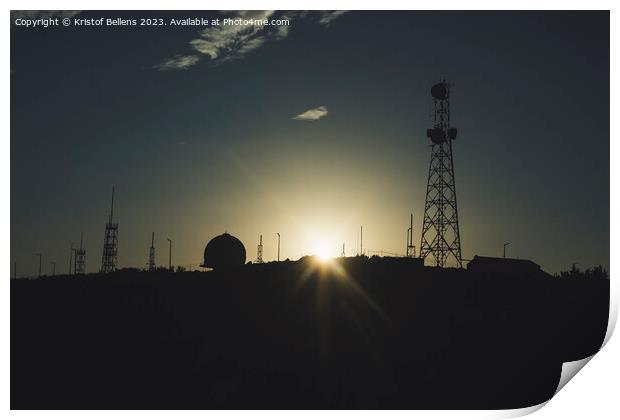 Silhouette of communication towers against a sunset. Print by Kristof Bellens
