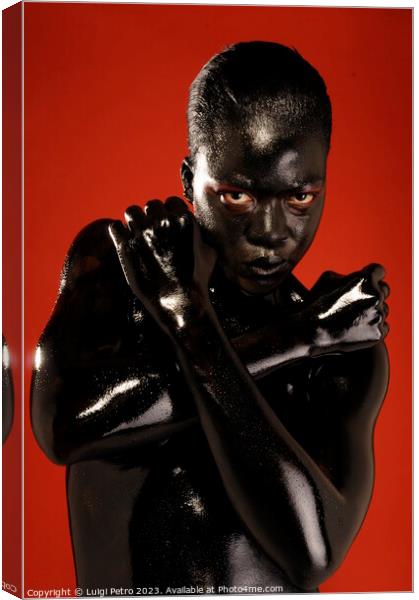 Black model covered in black body paint. Canvas Print by Luigi Petro
