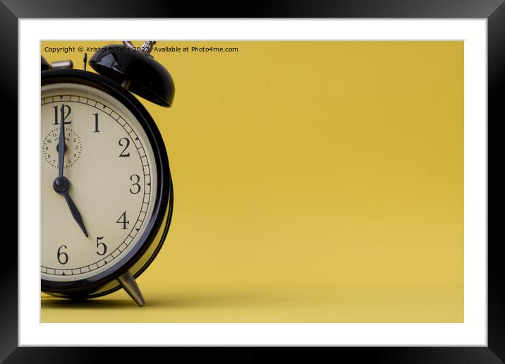 Analog alarm clock displaying five o'clock on a yellow background with copy space Framed Mounted Print by Kristof Bellens