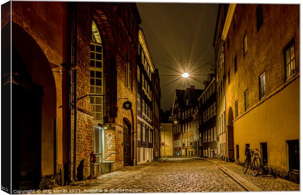 street lamp hanging over an alley at night in Copenhagen Canvas Print by Stig Alenäs