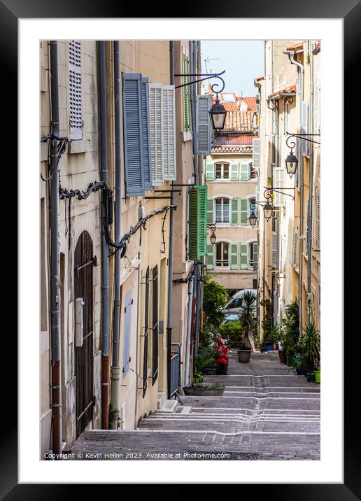 Steep, narrow street in old Marseille, France Framed Mounted Print by Kevin Hellon