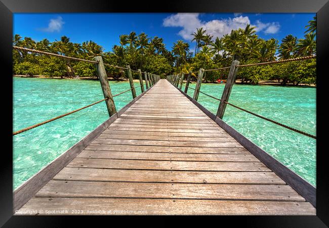 Bora Bora wooden walkway over tropical Aquamarine lagoon  Framed Print by Spotmatik 