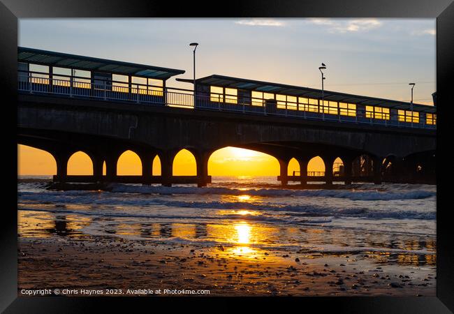 Sunrise on the sea under the arches Framed Print by Chris Haynes