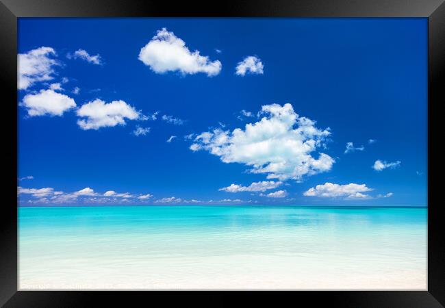 View of blue ocean and white sandy beach Framed Print by Spotmatik 