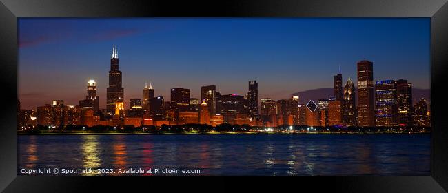 Panorama of Chicago city skyscrapers illuminated at dusk Framed Print by Spotmatik 